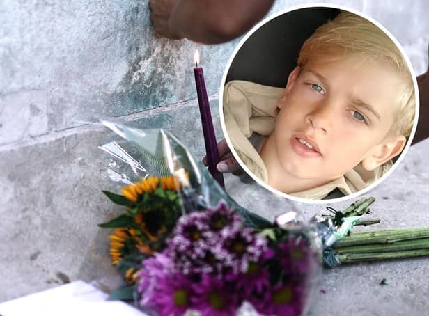 Archie Battersbee, inset, died on Saturday, August 6 after his treatment was withdrawn. Candles have been lit and flowers have been left outside the Royal London Hospital in Whitechapel. Pictures: Hollie Dance/PA.