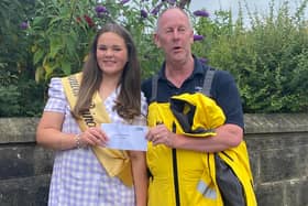 Summer Butterfield presents her £30 prize money to Hartlepool RNLI's Tom Collins.