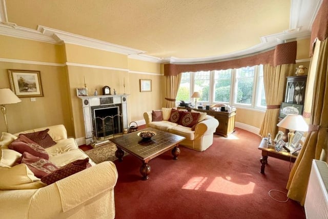The sitting room is flooded with light through the large bay window.