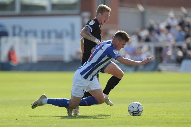 Carlisle United's Callum Guy battles for possession with Hartlepool United's Mark Shelton  during the Sky Bet League 2 match between Hartlepool United and Carlisle United at Victoria Park, Hartlepool on Saturday 28th August 2021. (Credit: Mark Fletcher | MI News)