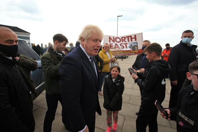 Prime Minister Boris Johnson greets members of the public as he campaigns on behalf of Conservative Party candidate Jill Mortimer (unseen) in Hartlepool, in the north-east of England ahead of the 2021 Hartlepool by-election to be held on May 6. Picture date: Monday May 3, 2021.