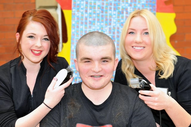 Hartlepool Sixth Form College student Ricky Adams gets his head shaved by Shannon Cummings and Rachel Hodgman in 2013.