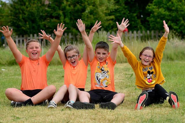 St Aidan's Primary school pupils (left to right) Logan Marshall, Poppy McDonald, Frankie Sheehan and Millei Sowerby cheer on their fellow pupils who are taking part in a charity run in memory of Keisha Watson.