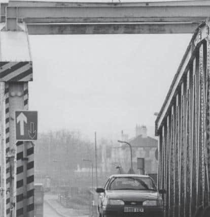 A car crosses the Middleton Bridge in the weeks shortly before its demolition.