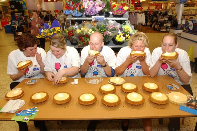 These workers at Tesco were eating custard pies for charity in 2003.