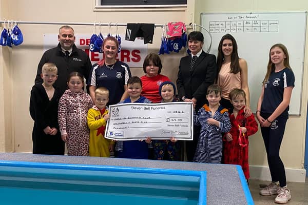 The money is presented to Hartlepool Swimming Club by Steven Bell Funerals.