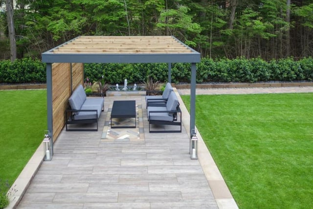 This home has a lot of outdoor space, including a number of seating areas, a pergola and raised beds.