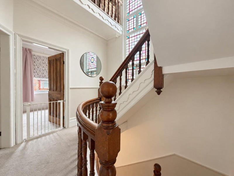 This home has a split level landing featuring a stained glass window.