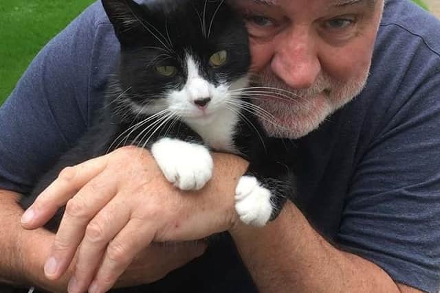 Alan Wright and Buster the cat in 2016.