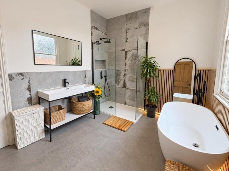 This good-sized family bathroom has a freestanding bath and separate double shower.