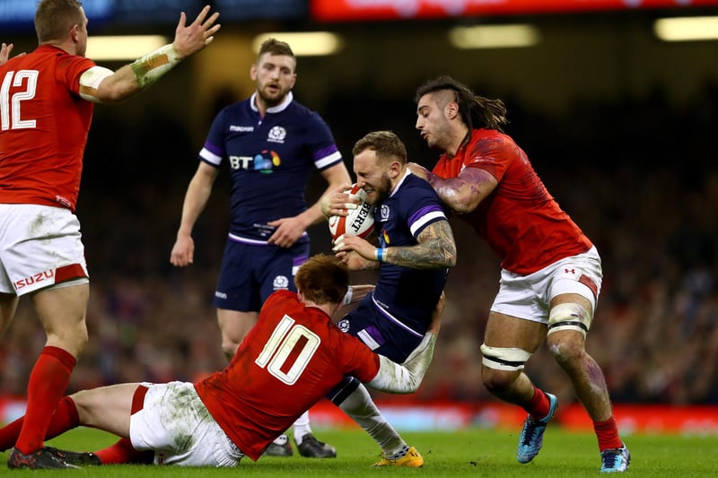Byron McGuigan of Scotland is tackled by Josh Navidi and Rhys Patchell of Wales during a Natwest Six Nations round one match at Cardiff's Principality Stadium on February 3, 2018.  (Photo by Michael Steele/Getty Images)