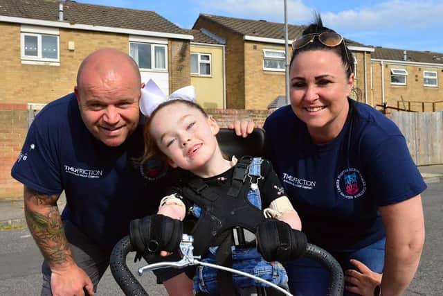 Tilly Grant on her specially adapted trike with Micky Day and Kelly Pearson from Miles for Men. Picture by FRANK REID