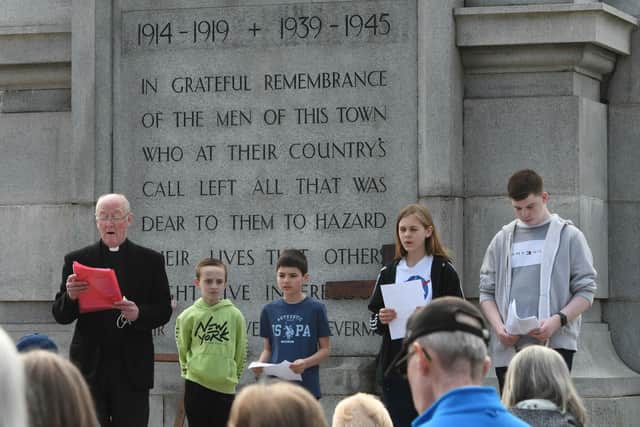 Father Michael Griffiths joined by youngsters who gave readings in the service.