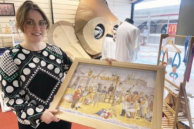 Kathryn Hall with a piece of art at The Monkey Business shop./Photo: Frank Reid