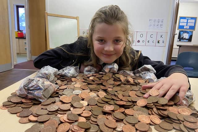 Hart Primary School pupil, Alice Brash, ready to bag the collection of 2p coins for charity.