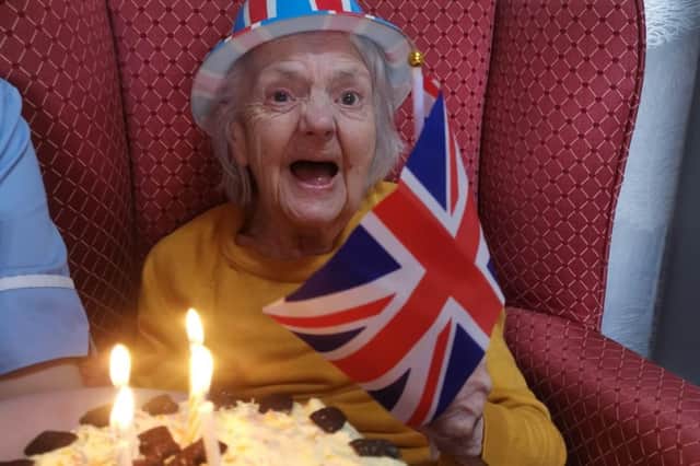 Isabella Crilley, a resident of Queens Meadow Care Home and WW2 Women’s Royal Air Force veteran with a cake to mark her 21st birthday as she was unable to mark the occasion in 1944 due to the war.