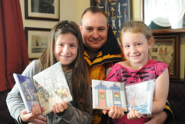 Hartlepool Lifeboat crew member Darren Killick pictured with daughters Emily and Rhianna who are holding some of the new RNLI Christmas cards that can be bought to raise funds for the local RNLI lifeboat station.