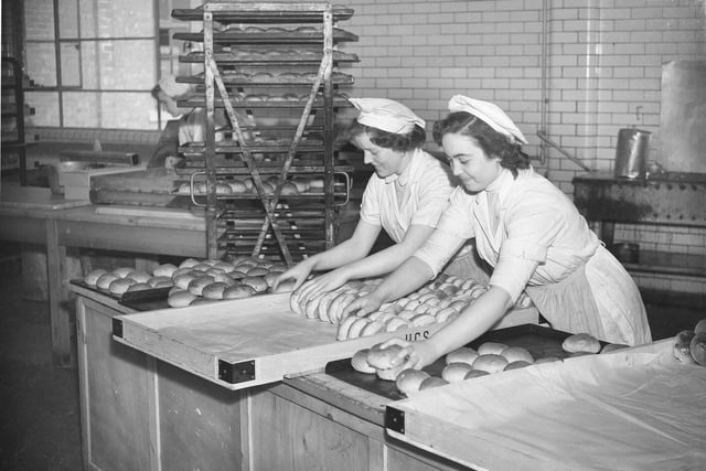 Co-op workers are pictured baking fresh bread for their customers.