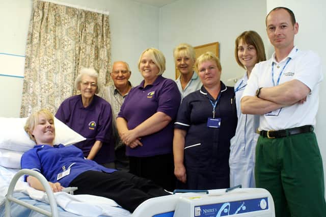 Kath Perks, Doug Knowles, and Diane Fletcher from the Joanna Knowles Trust presented a bed to Buxton Hospital staff  in 2007. Pictured Cas Watson, Andrea Bothamley, Alison Collins and Phil Roberts.