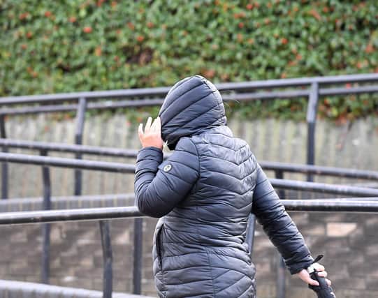 Leanne Wallace hides her face as she leaves Teesside Magistrates Court. Picture by Frank Reid.
