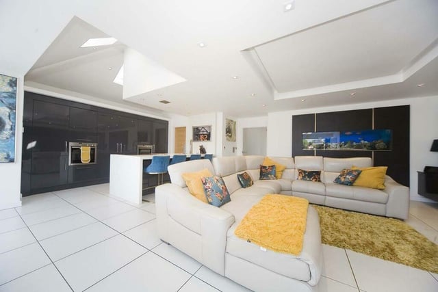 The open plan family room offers the perfect space for socialising and boasts a built-in aquarium.