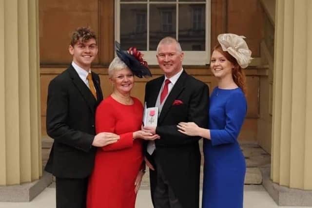 Alby with his family as he collected the MBE in 2018.