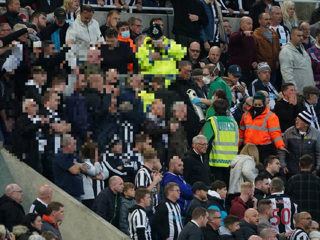 Medical personal were called to assist a fan in the stands during the Premier League match at St. James' Park, Newcastle. Picture PA.