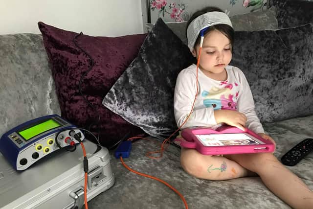 Lyla at home as she was hooked up a monitor to help treat her health condition.