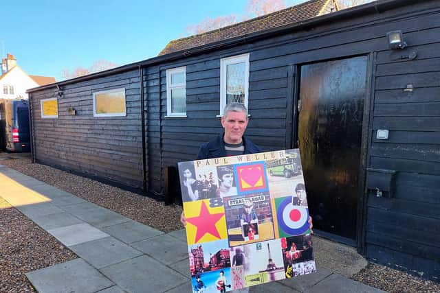 March of the Mods organiser Kev McGuire with the Paul Weller signed board which could be won at a raffle.