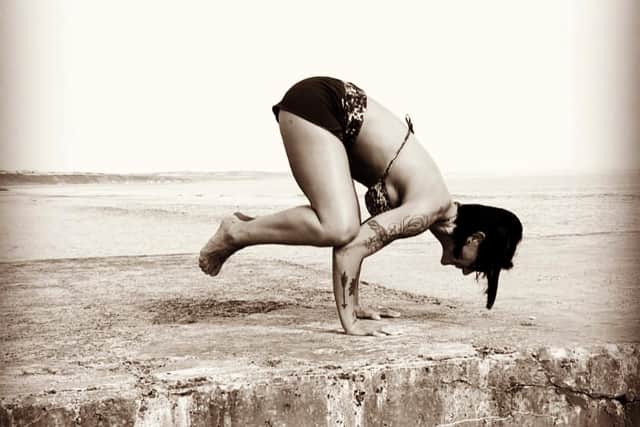 Cristina Moreira, instructor at Casa Yoga, practicing yoga by the sea, in Hartlepool.