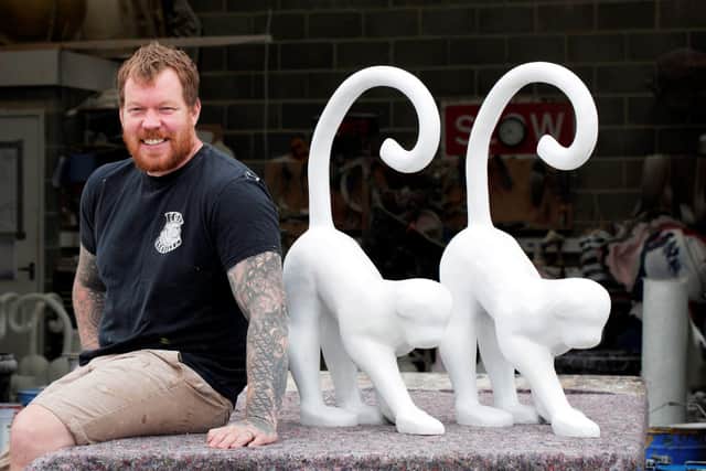 Prop maker Billy Cessford with the monkey sculptures he created.