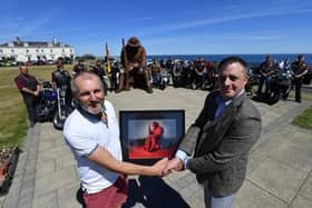 Lee Bullivant, right, gives Ray Lonsdale, left, a framed photograph of Tommy.