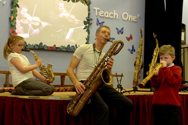 Saxophonist Snake Davis teaches Evie Stubbs and Ben Lloyd how to play the saxophone in 2013.