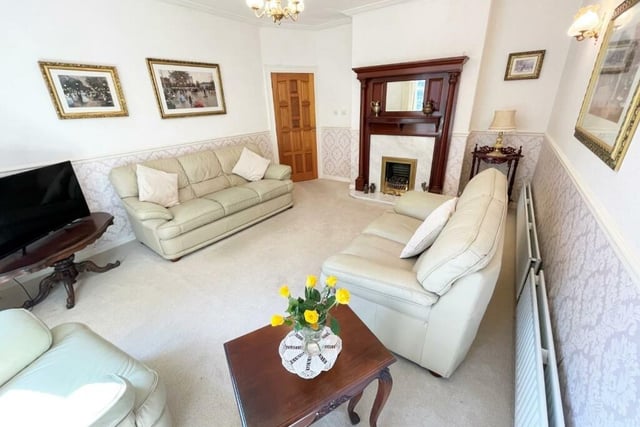 The cosy lounge of the home is complete with a fireplace and a bay window.