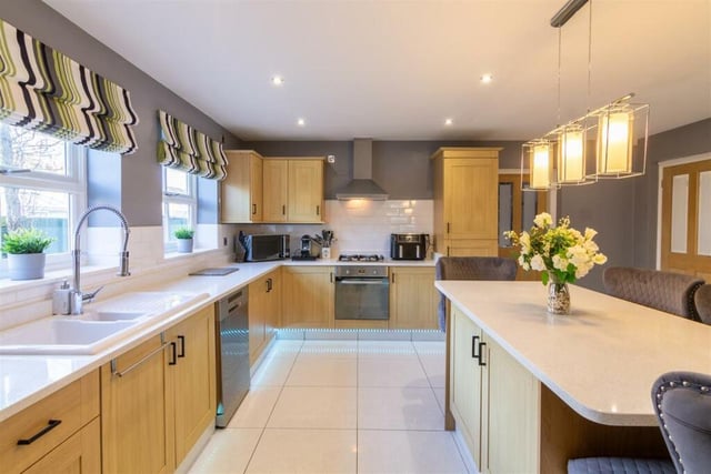 This property has a large contemporary kitchen and kitchen island.