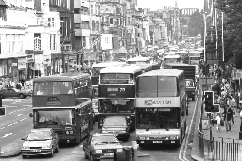 LRT and private companies' buses jostle for position at the traffic lights - heavy traffic in Princes Street during the Edinburgh Festival 1987.