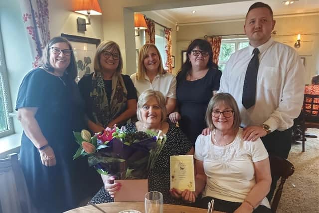 Helen Aisbitt (seated left) on her final day at Mason’s Funeral Service with colleagues Julia Masshedar (right) and (back) Geradeen Horsley, Lynne Noble, Carole Lester,
Tammy Radcliffe and Terry McCormack.