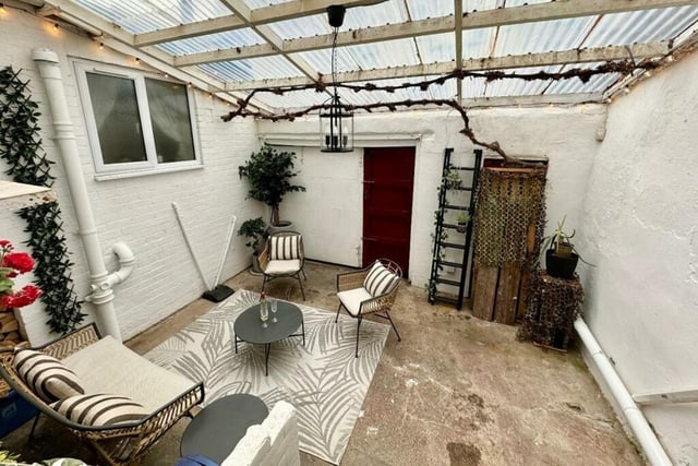 This backyard is currently being used as an entertainment space, but can also be used for off-street parking.