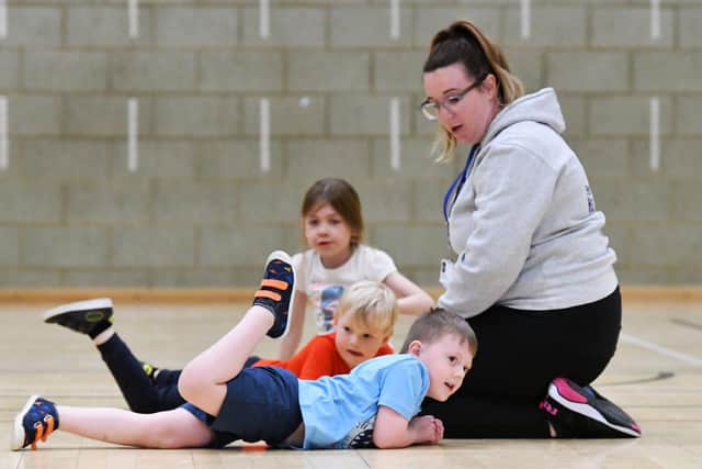 Vic Weighill enjoying a rough and tumble with Oliver Coraigan, Isaac Harland and Izabelle Berry during the Funability session held at Brierton Community Sports Centre.