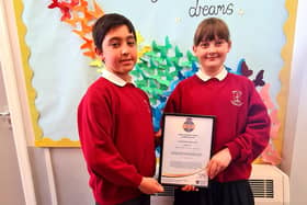 Two West View Primary School pupils show off the school's National Online Safety Certified School Accreditation.