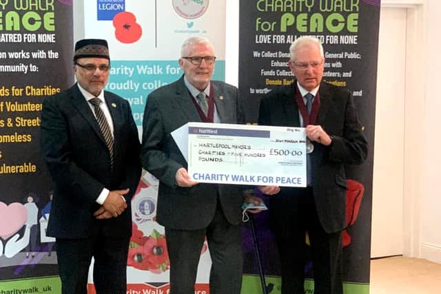 Zaheer Ahmad, the Chairman of  Charity Walk For Peace (left) as Deputy Mayor Cllr Rob Cook and Cllr Dennis Loynes receive a cheque for the late Brenda Loynes' chosen charities.