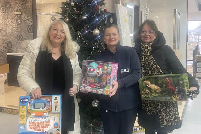 Lorna and Sue collecting gifts from MKM's Jane plant, centre, on behalf of Stranton Academy.