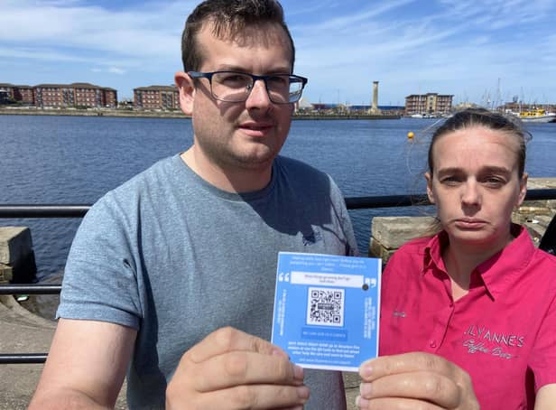 Trevor Sherwood and Angela Arnold of LilyAnne's Coffee Bar with one of the QR cards at Hartlepool marina. Picture by FRANk REID