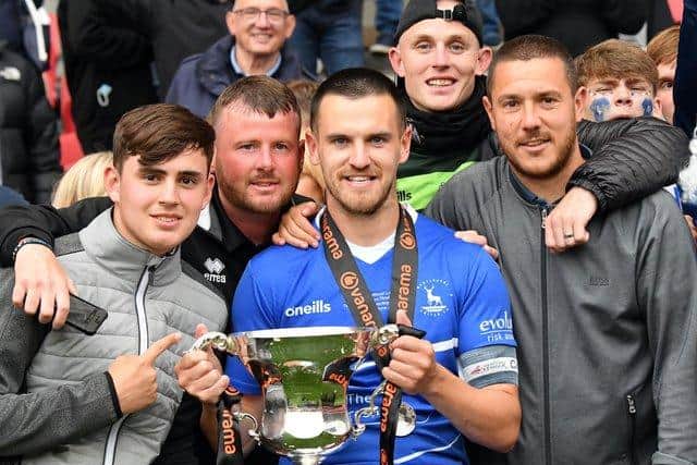 Hartlepool United captain Ryan Donaldson with the National League promotion final trophy. Former teammate and Morpeth Town midfielder Liam Noble (right)