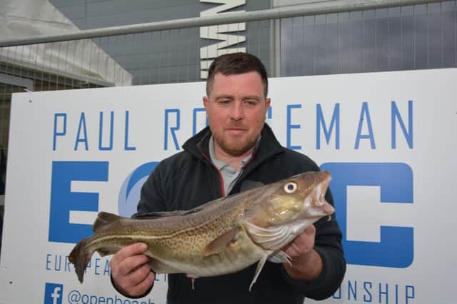 Scott Pippen Moore with a cod he caught during the competition.