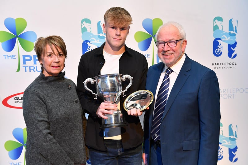 Hartlepool sports personality Luke Swales, who represents Pools Youth FC, receives his 2023 award from Judith and George Stannard. Picture by FRANK REID