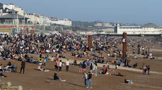 People enjoy the warm Spring weather on Brighton beach on March 30, 2021.  (Photo by Mike Hewitt/Getty Images)