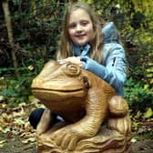 Emily Barker Fox with a frog sculpture.