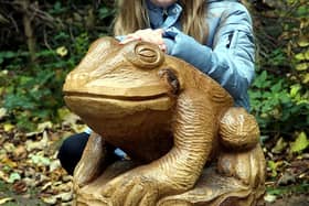 Emily Barker Fox with a frog sculpture.
