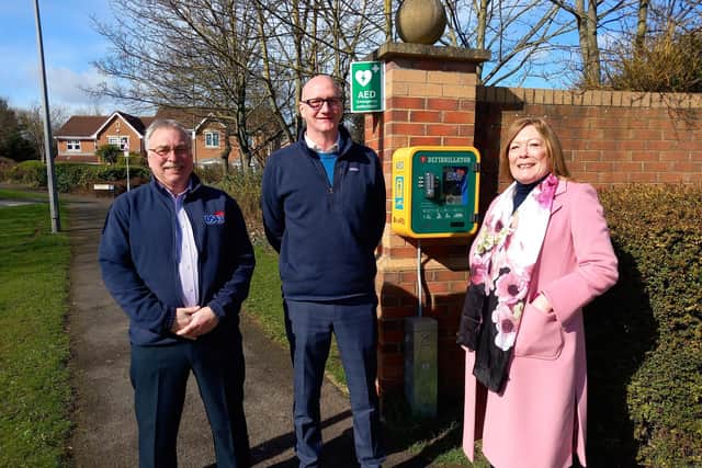 Left right: Bill Shurmer, Councillor Shane Moore and Pam Shurmer with an existing community defibrillator in Merlin Way, Hartlepool.